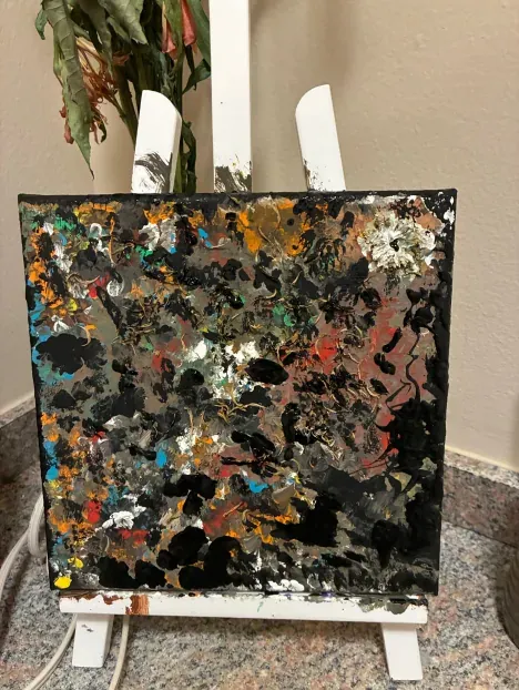 A dark canvas scattered with pale petals