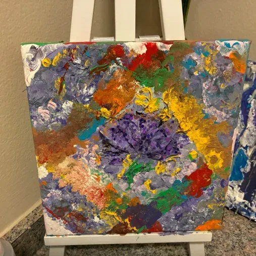 A bloom of purple, orange and white built up in palette-knife strokes